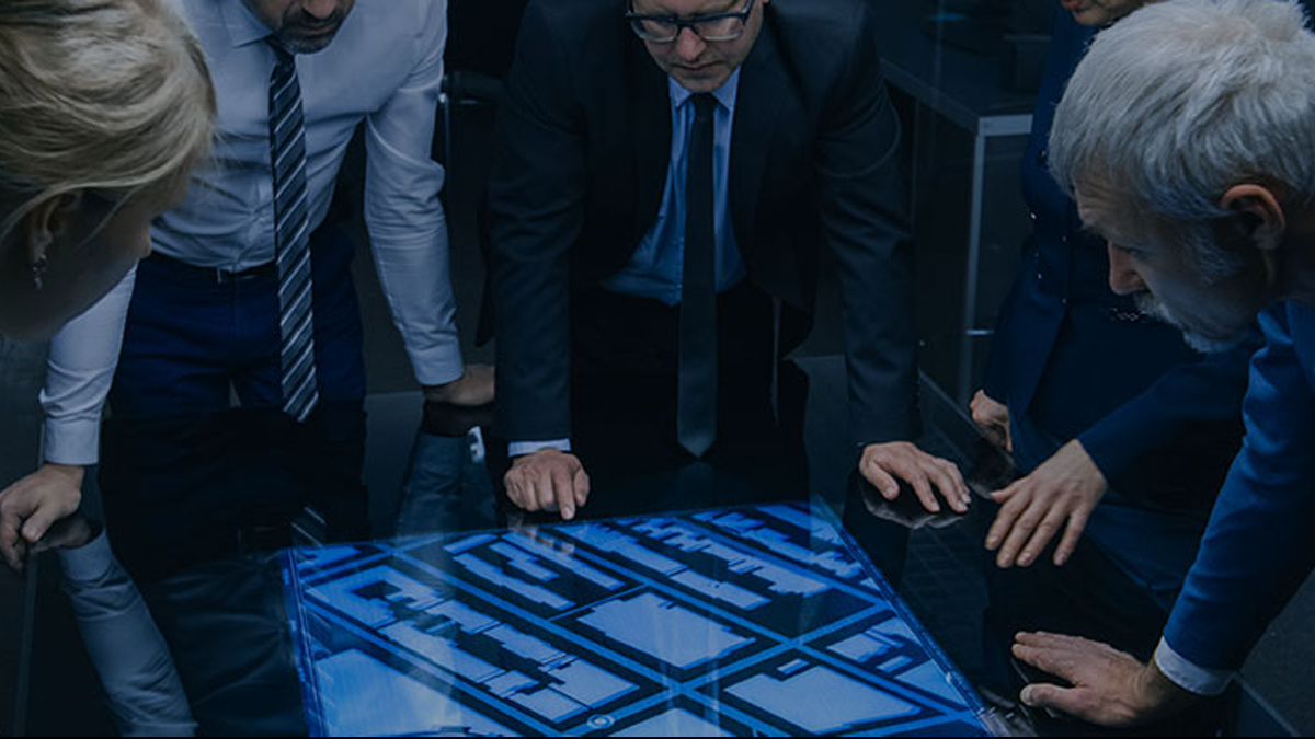 people looking at desk screen